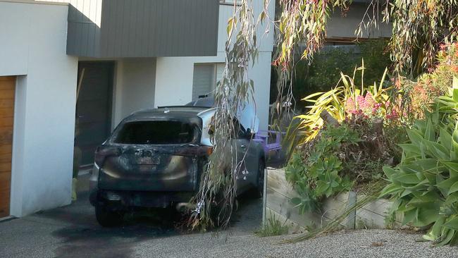 A car destroyed by fire in the driveway of a Jan Juc house in Marner Close. Picture: Alison Wynd