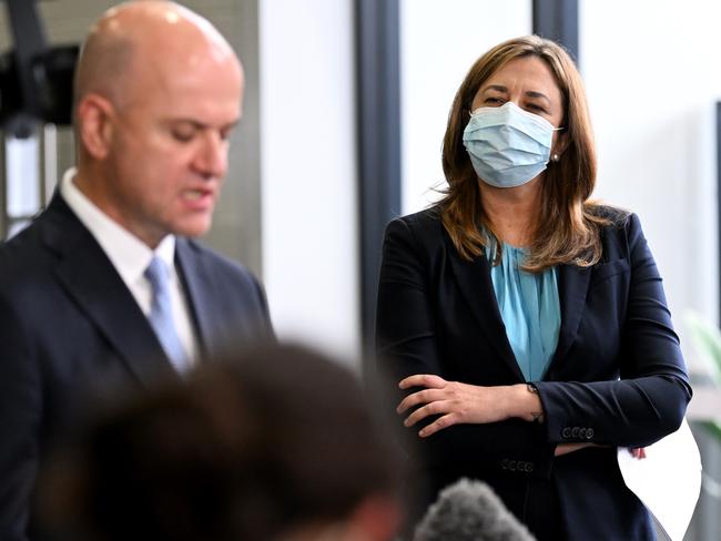 Premier Annastacia Palaszczuk watches Chief Health Officer John Gerrard speak yesterday. Picture: Dan Peled/NCA NewsWire