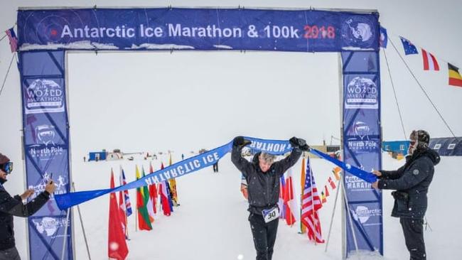 Justin Quill as he crossed the finish line at the Antarctic Ice Marathon. 