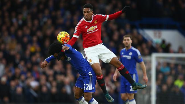 Anthony Martial and Willian go up for a header.