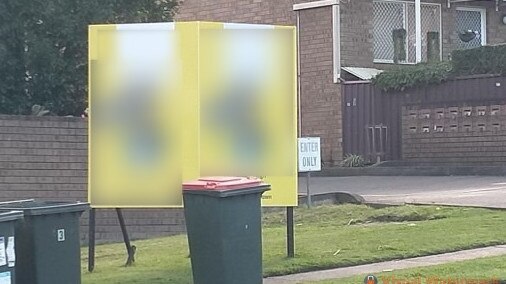 Some signs have been photographed by residents placed on nature strips outside homes. Note: photo blurred.