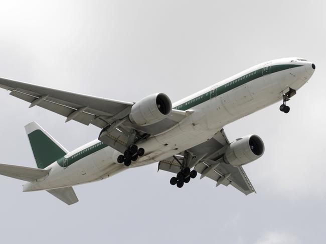 Modern widebody passenger jet passing overhead