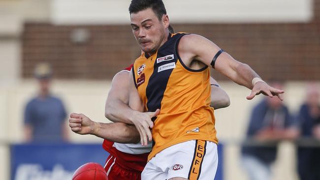 Nathan Grima tries to get a kick away for Strathmore. Picture: Valeriu Campan