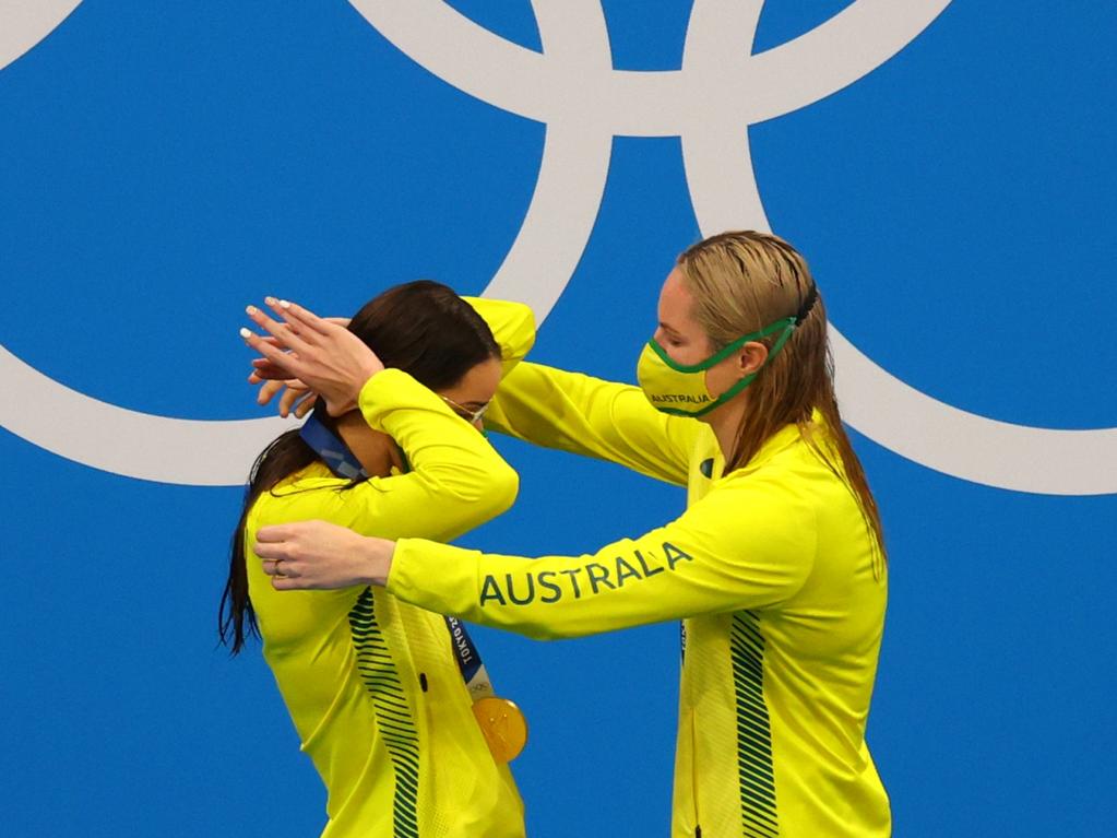 Emily Seebohm presents Kaylee McKeown with her gold medal for the 200m backstroke.