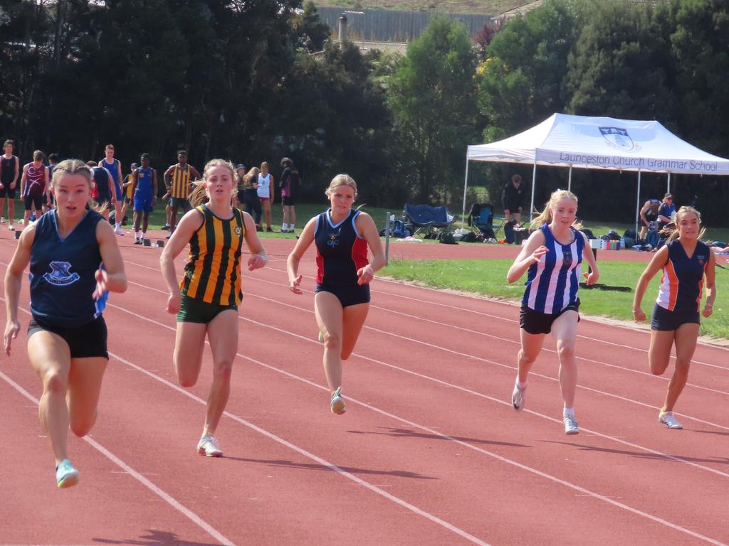 Chelsea Scolyer (far left) on her way to winning the open 100m final at the SATIS athletics carnival in Launceston on Tuesday. Picture: Jon Tuxworth