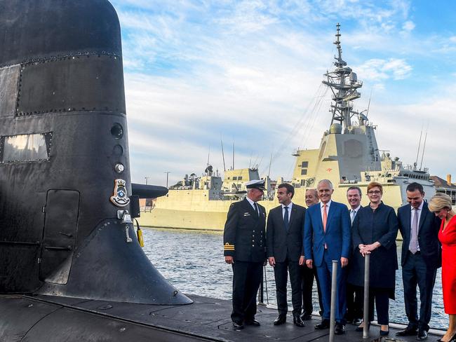 Happier times … French President Emmanuel Macron (2/L) and then Australian Prime Minister Malcolm Turnbull (C) standing on the deck of HMAS Waller, a Collins-class submarine operated by the Royal Australian Navy, at Garden Island in Sydney.