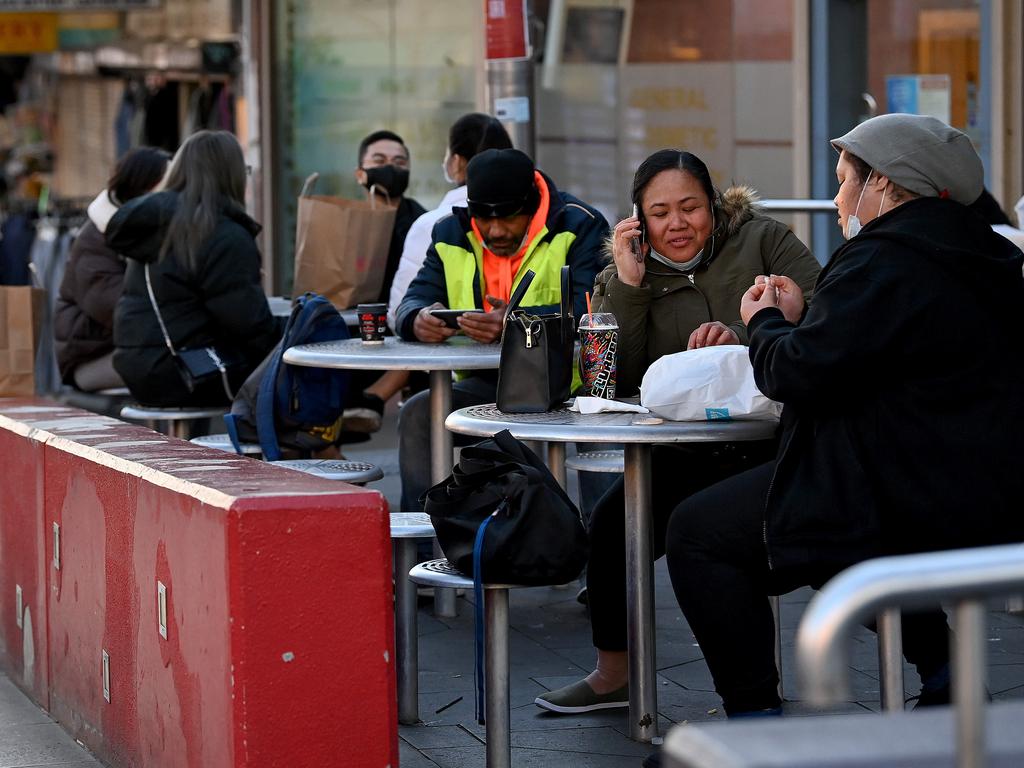 People not wearing face masks correctly gather at a food court on the main shopping strip of Bankstown in Sydney yesterday. Picture: Bianca De Marchi