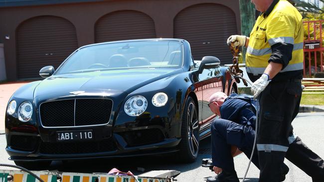 A police raid at Andrea Court, Broadbeach Waters resulted in 2 people being arrested, 2 cars, a jet ski and a motorbike being seized. Photo: Kit Wise