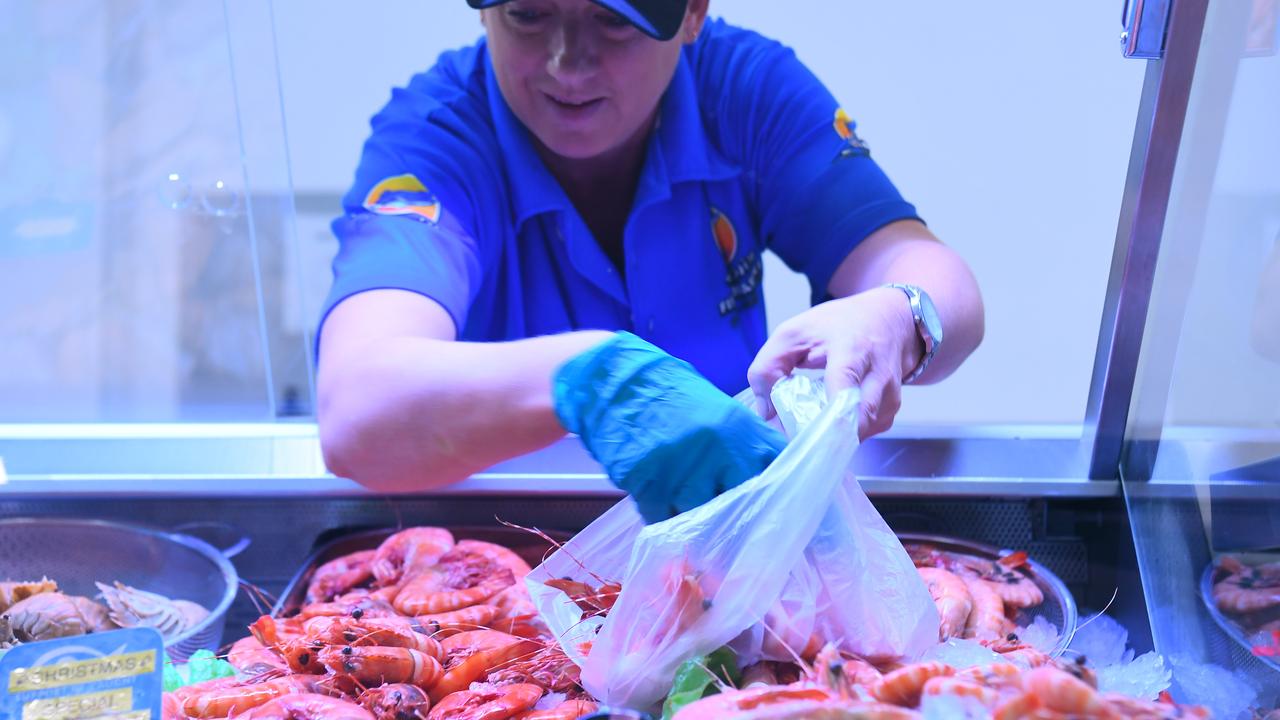 Holmes Seafood employee Nicole Halicek bagging up fresh NT prawns for the Christmas rush. Picture: (A)manda Parkinson