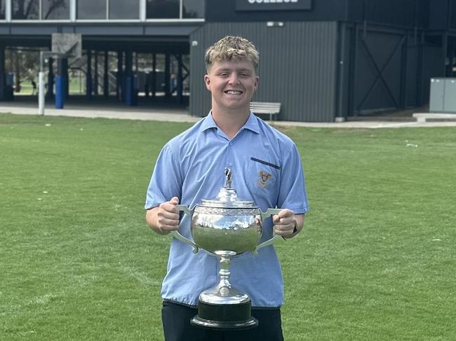 Marcellin College's Hayden Kenny with the AGSV first XI trophy after his grand final heroics. Picture: Supplied.