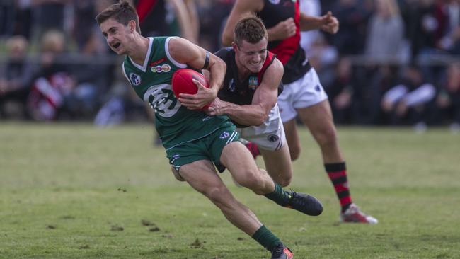 Greensborough’s Jacob Ireland can’t escape Bradyn Taglieri of Eltham Picture: Richard Serong