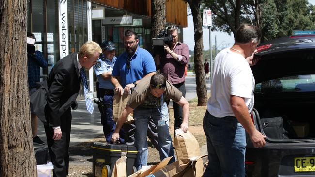 Police take away evidence during a raid of the group’s alleged safe house in Olympic Park. Picture: Craig Wilson