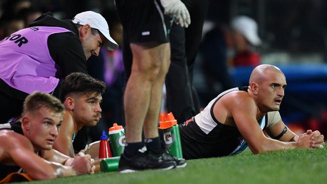 Sam Powell-Pepper gets some attention from the club doctor during the Showdown at Adelaide Oval on Saturday. Picture: AAP Image/David Mariuz