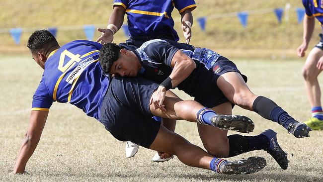 SJRU's Rodney Blake tackled by CCC's Savelio Tamale at recent trials