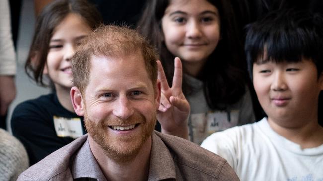 VANCOUVER, CANADA - NOVEMBER 18: Prince Harry, the Duke of Sussex, poses for a photo with elementary school students during the Invictus Games 2025 School Program Launch Event at Seaforth Armoury on November 18, 2024 in Vancouver, Canada. (Photo by Ethan Cairns/Getty Images)