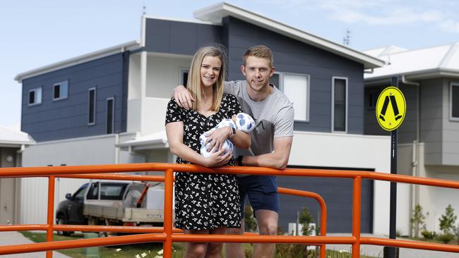 Kimberley and James Mueller, with baby Lennon, at their new home at Aura. Picture: AAP/Josh Woning