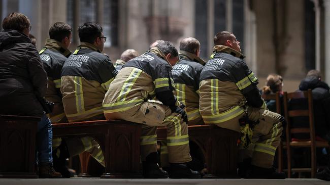 Firefighters attend a church service one day after a car-ramming attack on a Christmas market in Magdeburg, eastern Germany. Picture: AFP