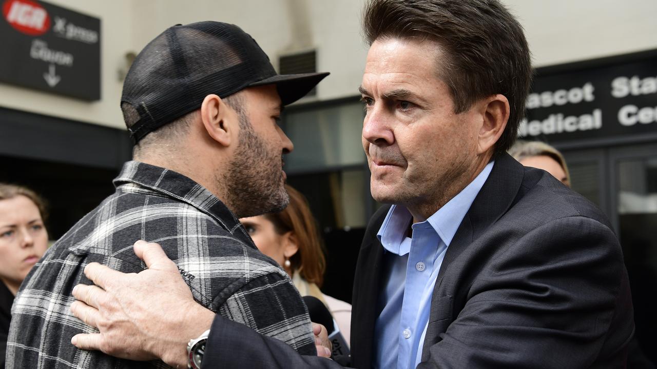 Mascot Towers apartment owner Fabiano Santos (left) gets an embrace from NSW Minister for Better Regulation and Innovation, Kevin Anderson (right) after a press conference at the Mascot Towers in Mascot, Sydney, Sunday, June 23, 2019. The NSW Government is offering an one-off temporary residential accommodation package for displaced residents of the Mascot Towers, after they were  evacuated as a precaution after cracks were discovered in the building. (AAP Image/Bianca De Marchi) NO ARCHIVING