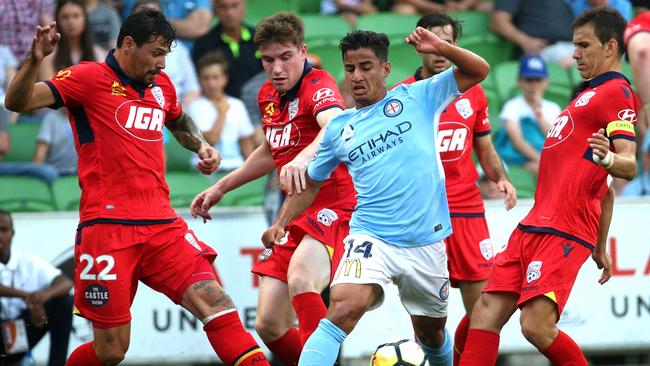 Daniel Arzani weaves through three defenders.