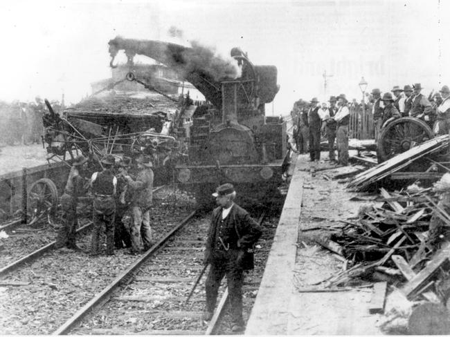 A steam-driven rail crane lifts wrecked carriages off the line after the Sunshine railway station disaster. Photo: Argus