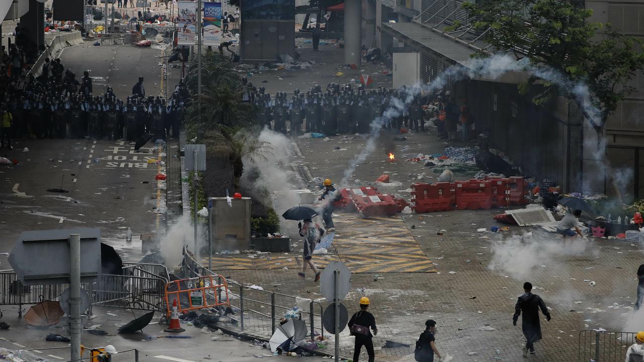 Riot police fire tear gas towards protesters outside the Legislative Council. Picture: Vincent Yu/AP