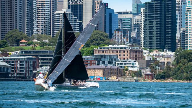 Fierce competition between two teams on Sydney Harbour. Picture: Thomas Lisson