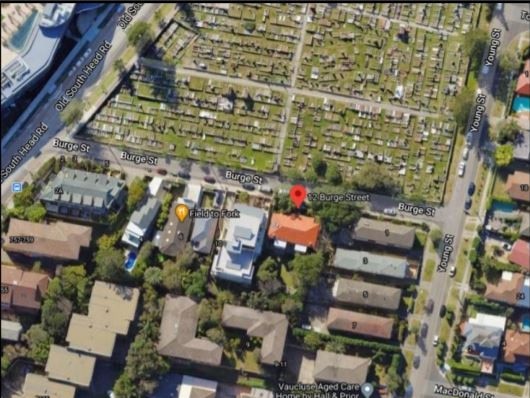 An aerial photograph shows the site, highlighted with the red dot, backing onto South Head Cemetery.