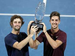 HE'S BACK: Thanasi Kokkinakis (right) and fellow Australian Jordan Thompson celebrate their win in the final of the men's doubles at the Brisbane International. Picture: DAVE HUNT