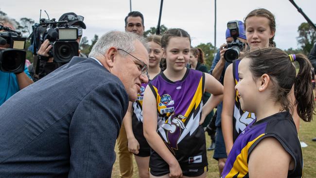 Mr Morrison talks to one of the young players from Norwood Sporting Club in Ringwood. Photo: Jason Edwards