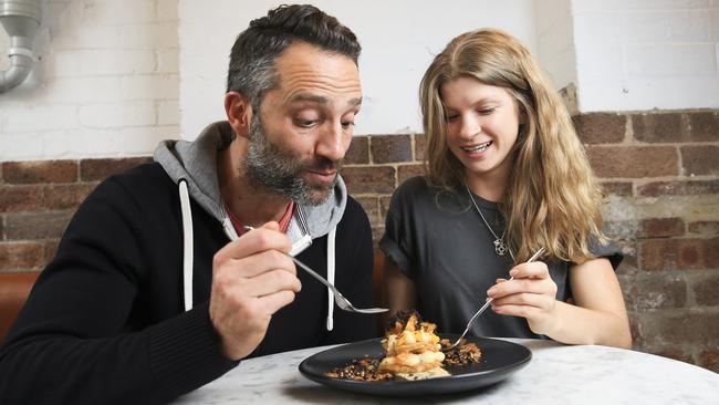 Toby Iaccarino and Sarah Maguire enjoy a truffle cookies and cream dessert at Three Williams cafe in Redfern; macadamia cookie, truffled mandarin crème patisserie, fresh mandarin, gold dust feulletine, dark choc crispearls and shaved truffle. Picture: Dylan Robinson