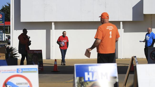 Party supporters wait to hand out information papers to voters at pre-poll for the Wagga Wagga by-election. Picture: Dylan Robinson