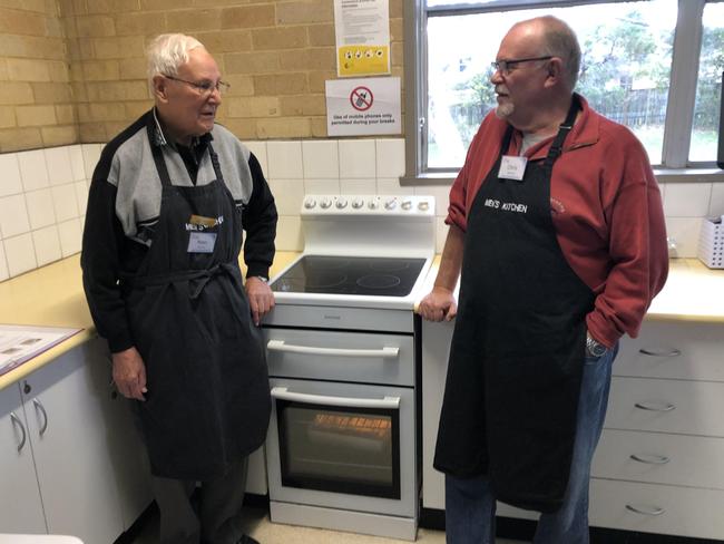 Peter Rudland (left) and Chris Bowen discuss dessert recipes during a Men's Kitchen Northern Beaches cooking skills session at the Forestville Community Hall on Friday. Picture: Jim O'Rourke