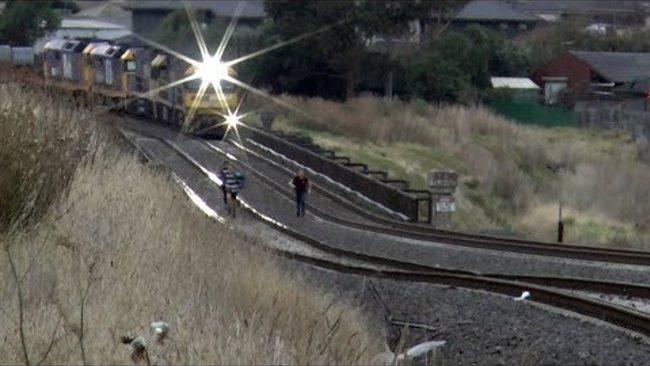 Freight Train Narrowly Misses Youths Playing on Tracks