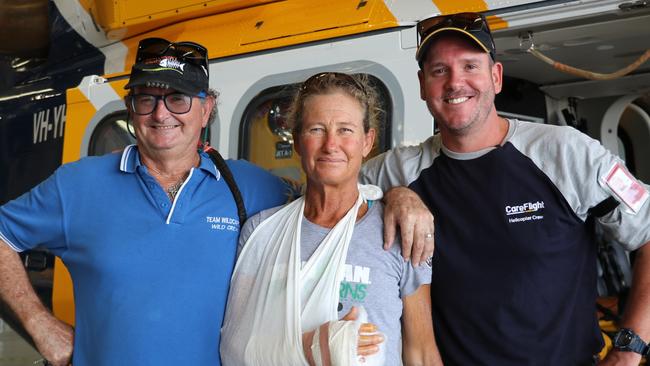 Juanita <s1>Davey and her husband Bruce with a CareFlight</s1>staffer after being rescued from remote Rimbija Island, where Ms Davey almost lost her hand. <source>Picture: Supplied</source>