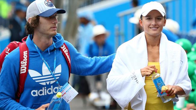 MELBOURNE, AUSTRALIA - JANUARY 14:  Tyrone Vickery, AFL footballer from the Richmond Tigers congratulates his wife Arina Rodionova after she won her match against Stephanie Vogt of Liechtenstein during the first round of 2016 Australian Open Qualifying at Melbourne Park on January 14, 2016 in Melbourne, Australia.  (Photo by Scott Barbour/Getty Images)