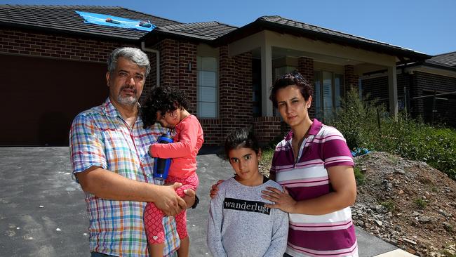 Behnoosh Khalaj, Sina Mavaddati and family outside their storm damaged home in Kellyville.