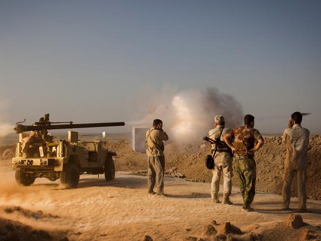 Iraqi Kurdish Peshmerga fighters fire a recoilless rifle towards Islamic State. AFP PHOTO/ JM Lopez