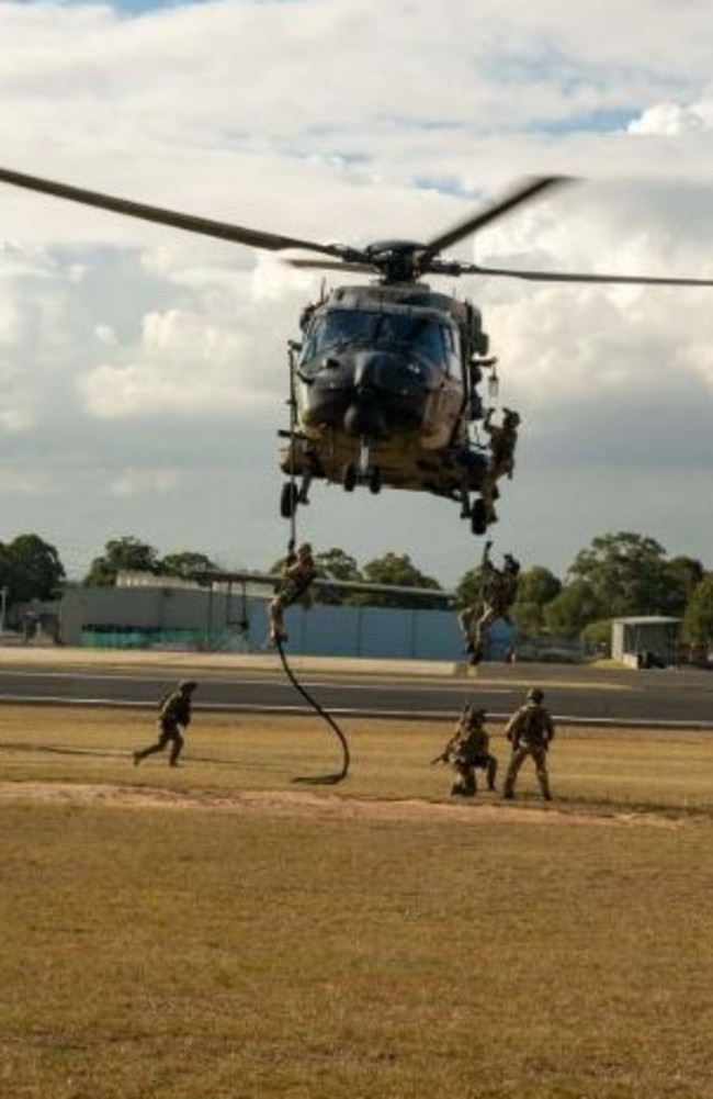 Operators from a US. Naval Special Warfare Unit and the Australian Army 2nd Commando Regiment climb aboard and “fast rope” from an MRH-90 Taipan helicopter from 6th Aviation Regiment at Holsworthy Barracks in Sydney during Talisman Sabre 2023. Picture: Mass Communication Specialist 1st Class Daniel Gaither/US Navy