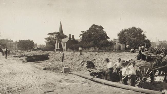 Labour gangs dug long trenches to painstakingly sift through the soil at the Devonshire St cemetery. Representatives of deceased persons had two months to arrange for relocation of remains. Picture: State Library of NSW