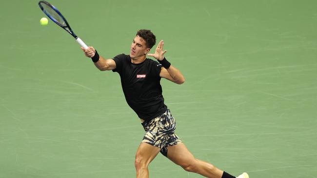 Thanasi Kokkinakis of Australia returns a shot against Nick Kyrgios