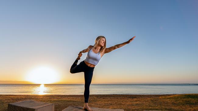 The Active Sisters’ Angelina Barth enjoys yoga on the beach. Picture: Dominika Lis