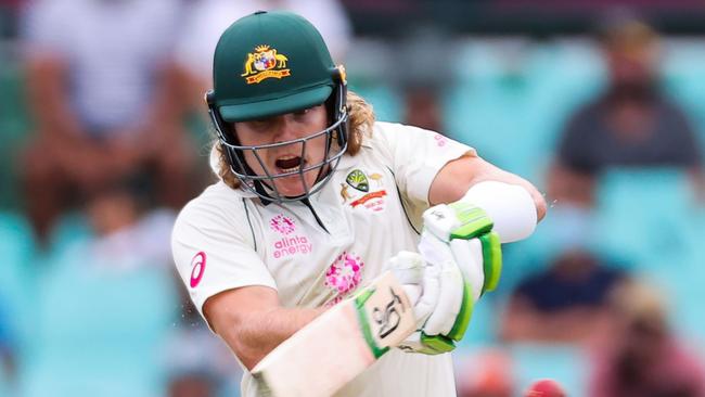 TOPSHOT - Australia's Will Pucovski plays a shot during the first day of the third cricket Test match between Australia and India at the Sydney Cricket Ground (SCG) in Sydney on January 7, 2021. (Photo by DAVID GRAY / AFP) / — IMAGE RESTRICTED TO EDITORIAL USE - STRICTLY NO COMMERCIAL USE —