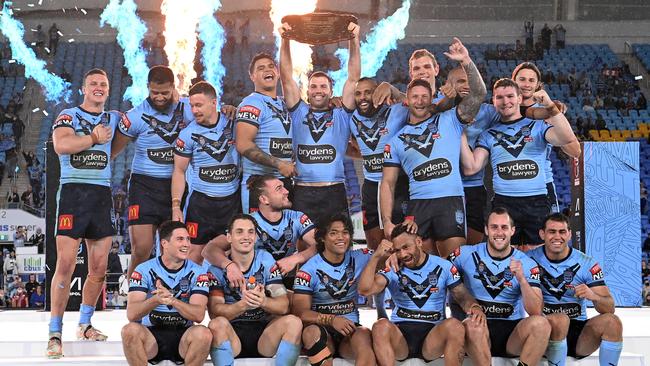 James Tedesco holds aloft the Origin shield and celebrates with teammates after winning the series 2-1. Picture: Getty Images