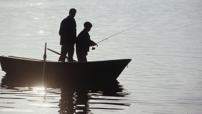 Silhouettes of father and son (13-14) standing in boat fishing Thinkstock image for The Courier-Mail CM2 fishing pointer on dangers of fishing, injuries etc. 30 August 2013 One time use only.