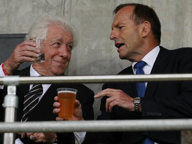 Frank Lowy and Tony Abbott, who appears to be doing his best Bob Hawke impersonation.