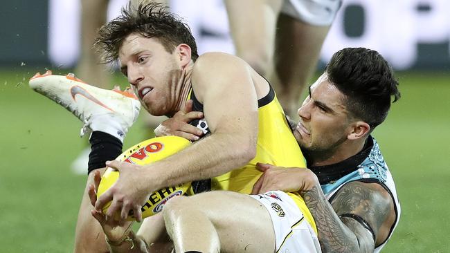 Chad Wingard wraps up Reece Conca in a tackle. Picture: Sarah Reed