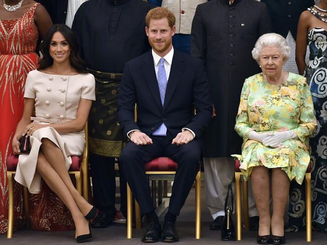 Britain's Queen Elizabeth, Prince Harry and Meghan, Duchess of Sussex pose for a group photo, June 2018. The Queen adopted a warm tone in today’s statement. Picture: John Stillwell/Pool Photo via AP