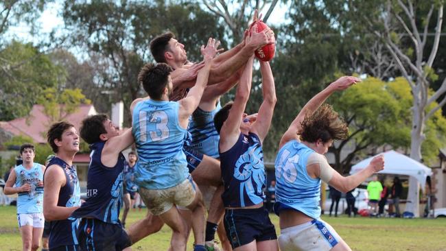 Glenunga's James Wundke and Michael McMahon both lay hands on a mark in the Rams' win over Sacred Heart Old Collegians on Saturday. Picture: Max Stapleton