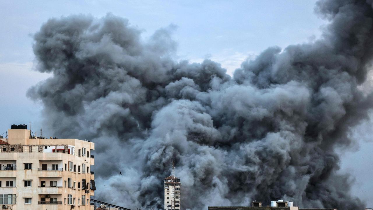 A plume of smoke rises above buildings in Gaza City during an Israeli air strike. Picture: AFP