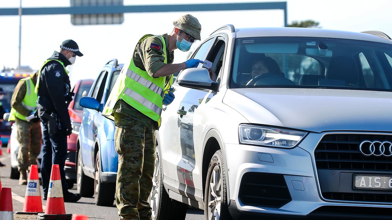 Victoria Police and Australian Defence Force personnel inspect cars at a vehicle checkpoint on the Princes Highway at Little River, near Geelong. Picture: NCA NewsWire / Ian Currie